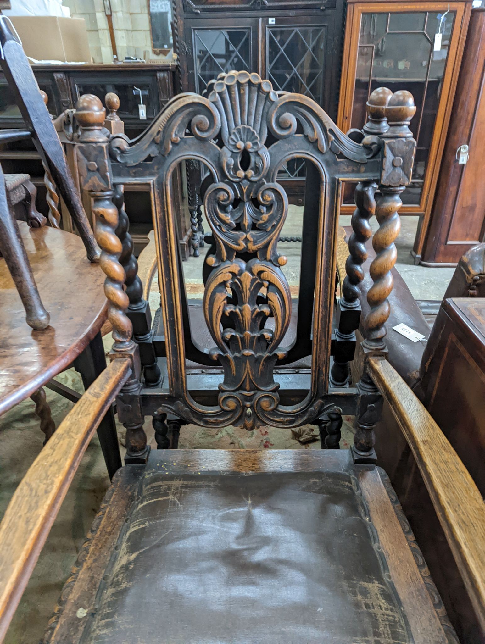 A harlequin set of six early 20th century oak dining chairs, two with arms